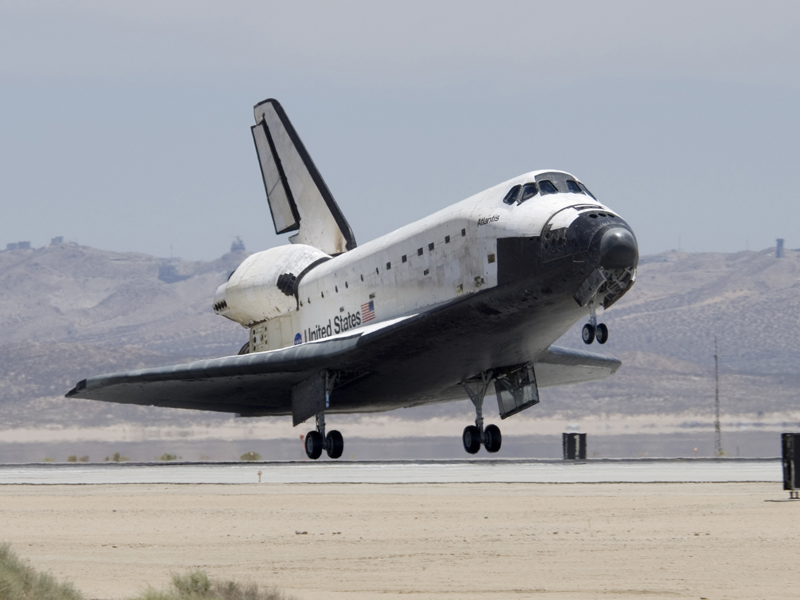 The Space Shuttle was a reusable craft. The winged orbiter would glide back to Earth after a mission and land like a conventional aircraft